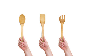 hand holding a wooden spoon on isolated white background