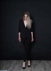 Photo of a fashion girl on a black background in black clothes light skin