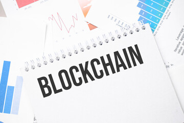 blockchain text on paper on the chart background with pen