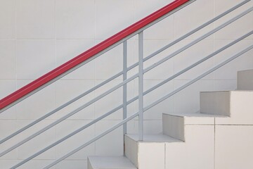 Modern Tiled Staircase Or Stairway With Iron Guard Hand Railing At The White Wall Background. Side View. Selective Focus.