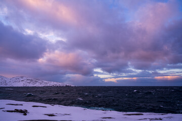 Cloudy weather conditions in the Arctic region, natural scenery along the Arctic Ocean. Winter nature background picture.