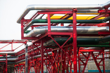 Fototapeta premium Steel pipelines, valves and ladders in an industrial enterprise