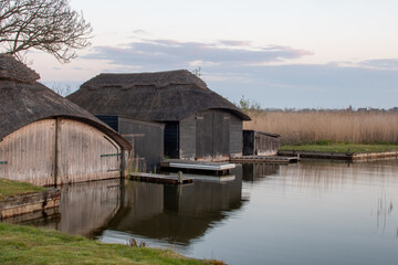Boat houses at Hickling Broad in the Norfolk Broads, UK. © Christopher Keeley