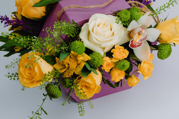 Floral arrangement with roses, alstroemeria, cymbidium and minirosa santini.
