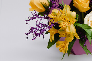 Floral arrangement with roses, alstroemeria, cymbidium and minirosa santini.
