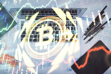 Blockchain theme hologram drawings over computer on the desktop background. Top view. Multi exposure. Concept of cryptoeconomy.