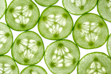 Fresh sliced cucumber slices isolated on a white background. Cucumber slices in light. Top view