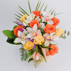 Ceramic vase with roses, cymbidium, alstroemeria and greenery.