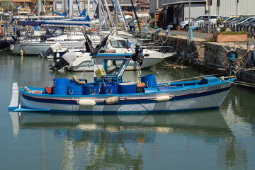 Fototapeta na wymiar Small Blue and white fishing boat with Ultrasonic equipment for fishing boats,at Fiumicino port, Lazio, Italy 