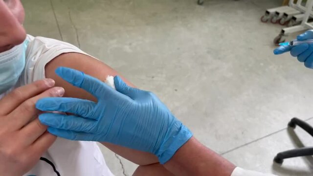 Hand of medical staff injecting coronavirus covid-19 vaccine.