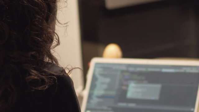 Young IT developer woman coding on her laptop, working remotely, working from home consept during the pandemic