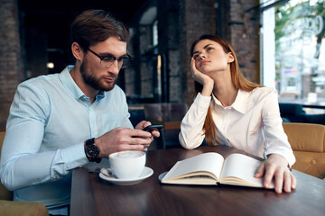 work colleagues in a cafe sit at the breakfast table communication