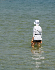 A Woman Standing in Shallow Sea Water