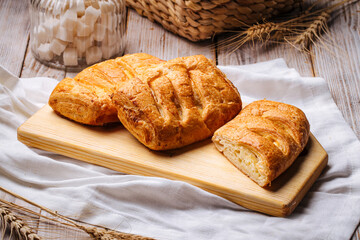 Side view on fresh baked puffs with cheese filling