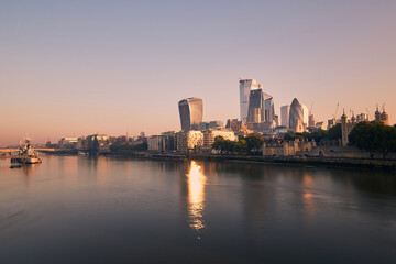 View of riverbank Thames River against skyscrapers. Urban skyline of London at morning light , United Kingdom..