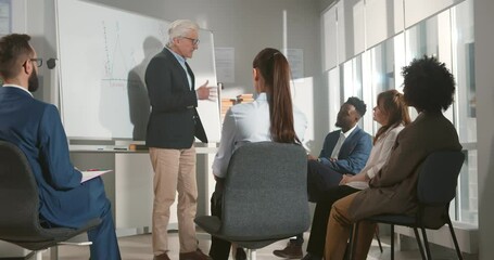 Company executive presenting new management strategy to team in conference room.