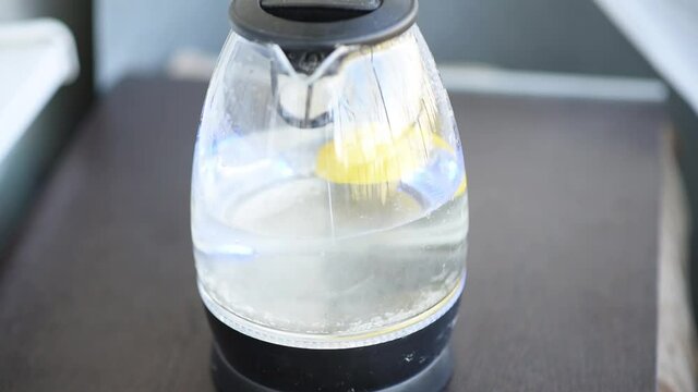 Easy way to descale glass electric kettle by boiling a half of lemon. Fast shooting