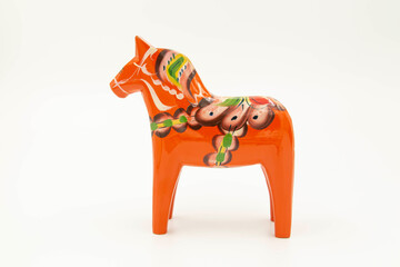 Red dalecarlian horse looking to the left, on white background, horizontal, studio shot