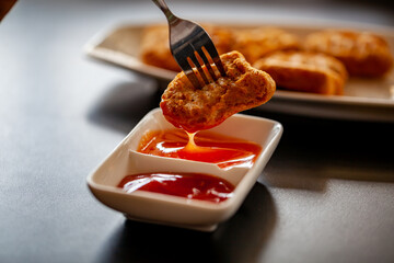 Chicken nuggets with a sauce add more flavor to the taste.