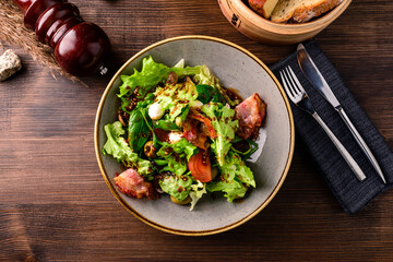 Healthy green salad with prosciutto, mozzarella and vegetables