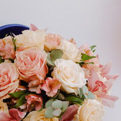 Round royal blue velvet box with white roses and pink alstroemeria and cymbidium.