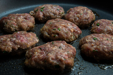 Homemade meatballs are cooked in a cast iron pan. Selective Focus  meatballs.