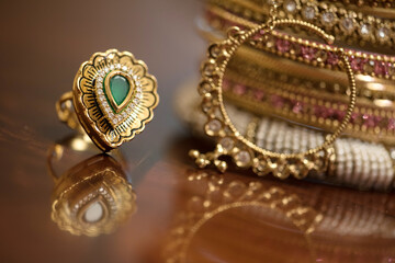 Golden ring with green stone and indian bracelets