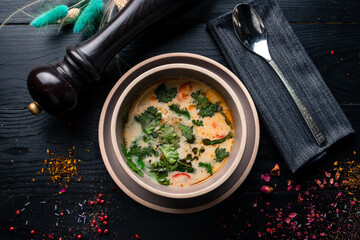 Tom Yum Kung, Thai spicy shrimp soup over wooden table