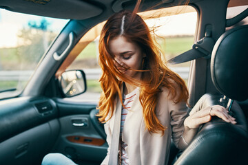 Fototapeta na wymiar woman in front seat of car turned back and window design salon travel companion travel tourism