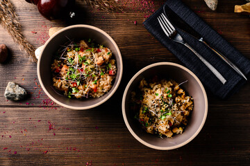 risotto with micro-greens. Raw vegan vegetable risotto and microgreens in bowl on rustic wooden background.