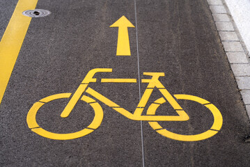 Yellow bicycle street marking for bicycle lane. Photo taken May 14th, 2021, Zurich, Switzerland.