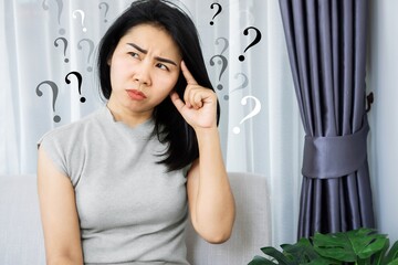 Asian woman having problem with Obsessive-Compulsive Disorder, forgetful and Alzheimer concept with question mark in her mind - obrazy, fototapety, plakaty