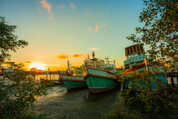 Many boats moored in sunrise morning time at Chalong port, Main port for travel ship to krabi and phi phi island, Phuket, Thailand