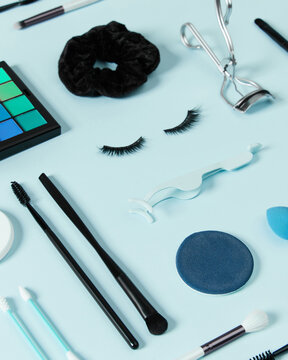 Creative layout with make up accessories on pastel blue background