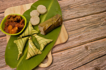 Malay traditional food called as Lemang and Ketupat rice or Ketupat Palas. Glutinous rice is wrapped with banana leaf, eaten with beef, chicken rendang and serunding.