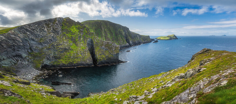 Large panorama with tall Kerry Cliffs and a view on Skellig Michael island where Star Wars were filmed, Iveragh peninsula, Ring of Kerry, Ireland
