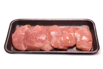 Turkey fillet in a black plastic container isolated.