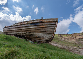 Fototapeta na wymiar Old Beached Wooden Boat