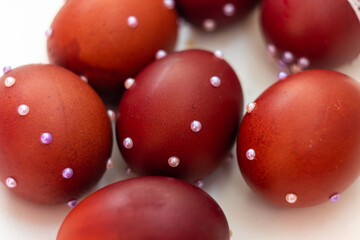 Several brown chicken eggs with white beads