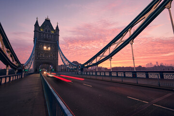 Traffic on Tower Bridge at beautiful dawn. Urban skyline of London, United Kingdom.
