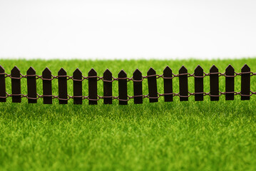Green grass and fence isolated on white background.