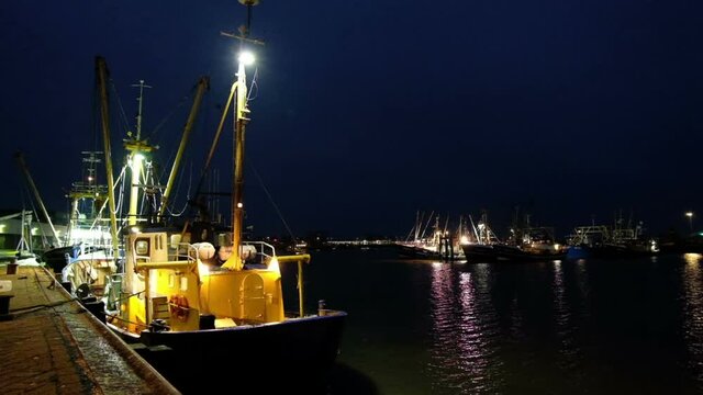 Fisherboats in the harbor from Lauwersoog in the Netherlands by night