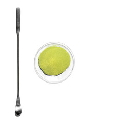 Optiblanc MBT green powder in Chemical Watch Glass placed next to the stirring rod on laboratory table.