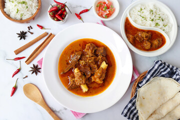 Shahi Mutton curry, Mutton masala, Mutton korma is a famous Spicy non-vegetarian dish of India. It's made out of Goat meat along with spices. Served with rice and roti. copy space.