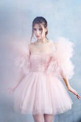 Mysterious young woman in elegant beautiful airy luxury evening trendy dress