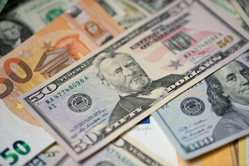 Fifty dollar bills next to euro bill. Currency exchange concept from euro to US dollar money.