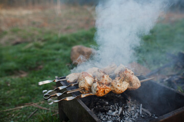 The meat is fried on a street grill. Meat and grill.
