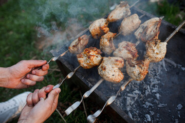 The meat is fried on a street grill. Meat and grill.