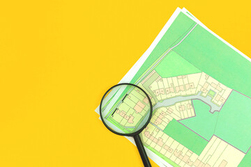 House real estate audit and purchase concept flat lay backrgound, cadastral map with magnifying glass on it, top view, building plot of land photo