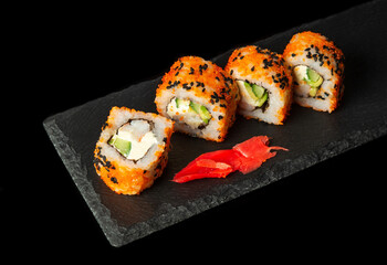Traditional Asian food sushi. Philadelphia with salmon, avocado and cheese. Japanese cuisine on black background